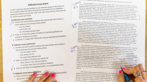 An overhead image of hands writing on papers on a wooden table.