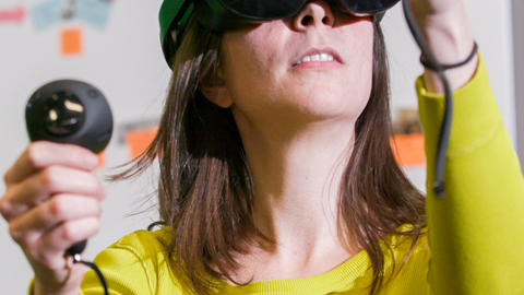 Christine D'Auria, Assistant Director of the Learning Lab, demonstrating a VR headset.