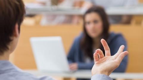 individual teaching in front of students in lecture hall