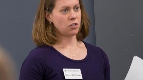Rebecca Brown teaching in front of a chalkboard