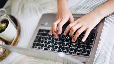 hands typing on laptop