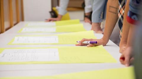 A photo of people giving feedback on assignments