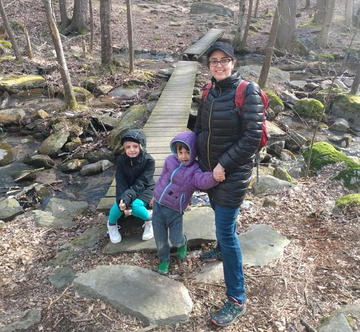 Sarah Emory on a hike in the woods with her children