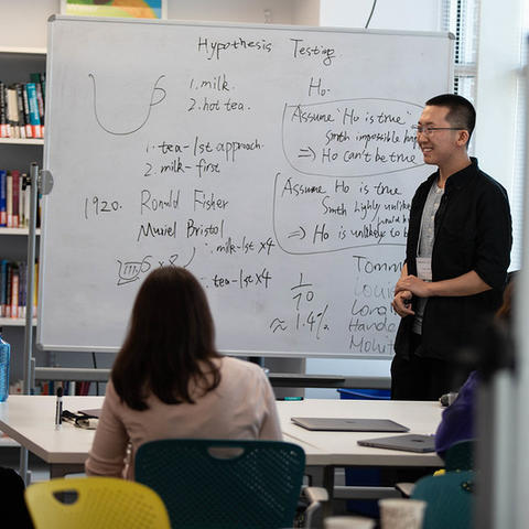 Pedagogy Fellow Longlin Wang teaches a mini-lesson to his peers.