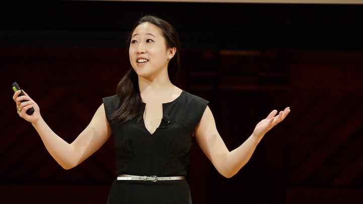 A Harvard Horizons scholar gives her presentation on stage at Sanders Theatre.
