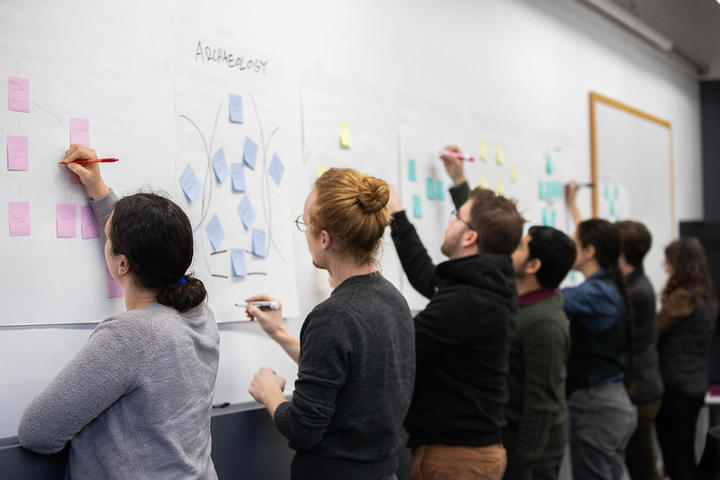 Pedagogy Fellows write on post it notes