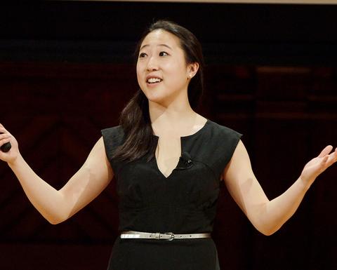 A Harvard Horizons scholar gives her presentation on stage at Sanders Theatre.