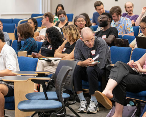 Students talk together in a lecture hall during the Fall Teaching Week.